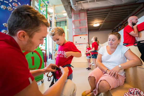 HAPIK harnessing kid before climbing